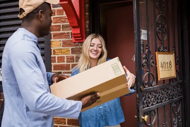 Happy customer accepting a package from a delivery person.